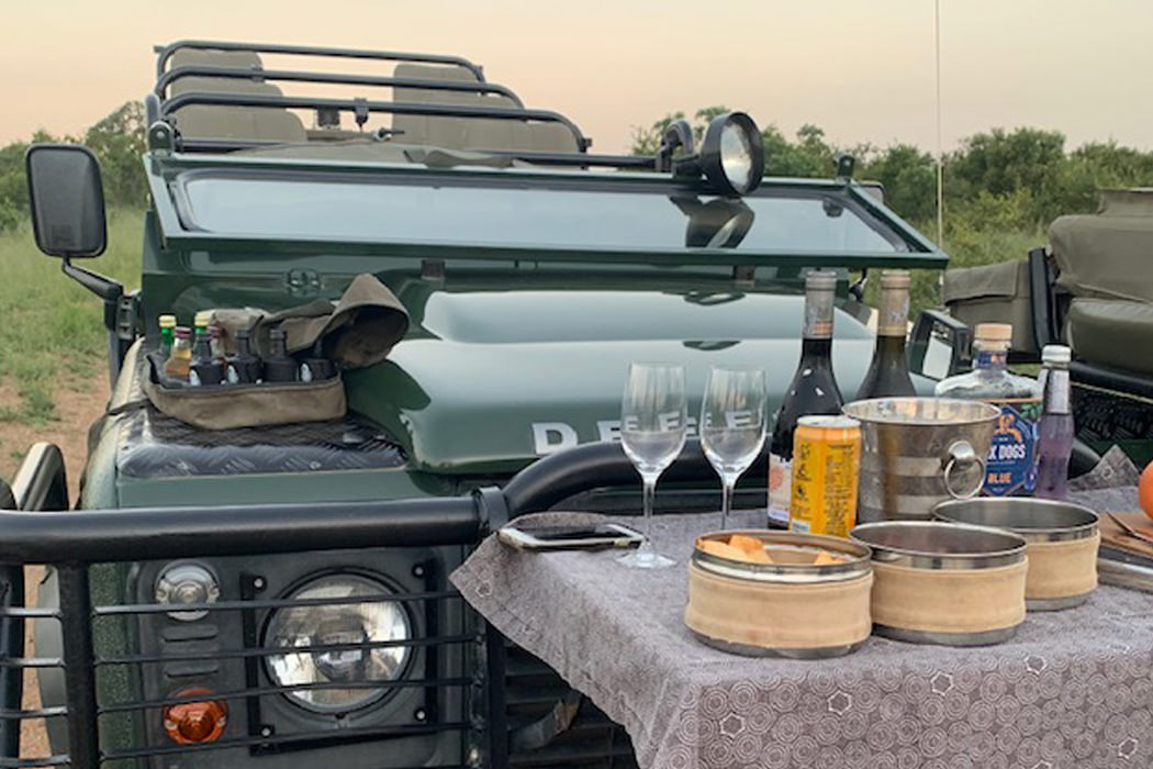 Photo of a LandRover with champagne on a table